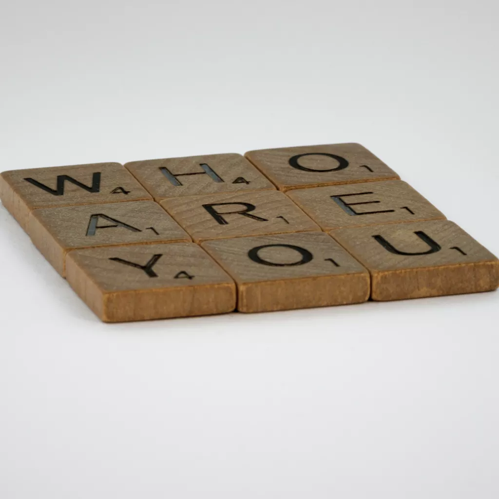 "Who are you?" written on tiles.