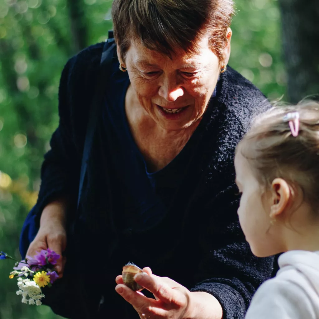 Grandmother showing her granddaughter something of interest.