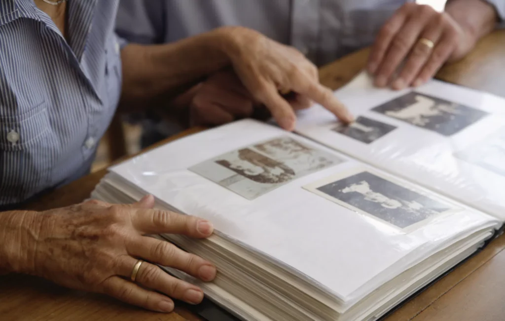 A family exploring their family history by reviewing old family photos.