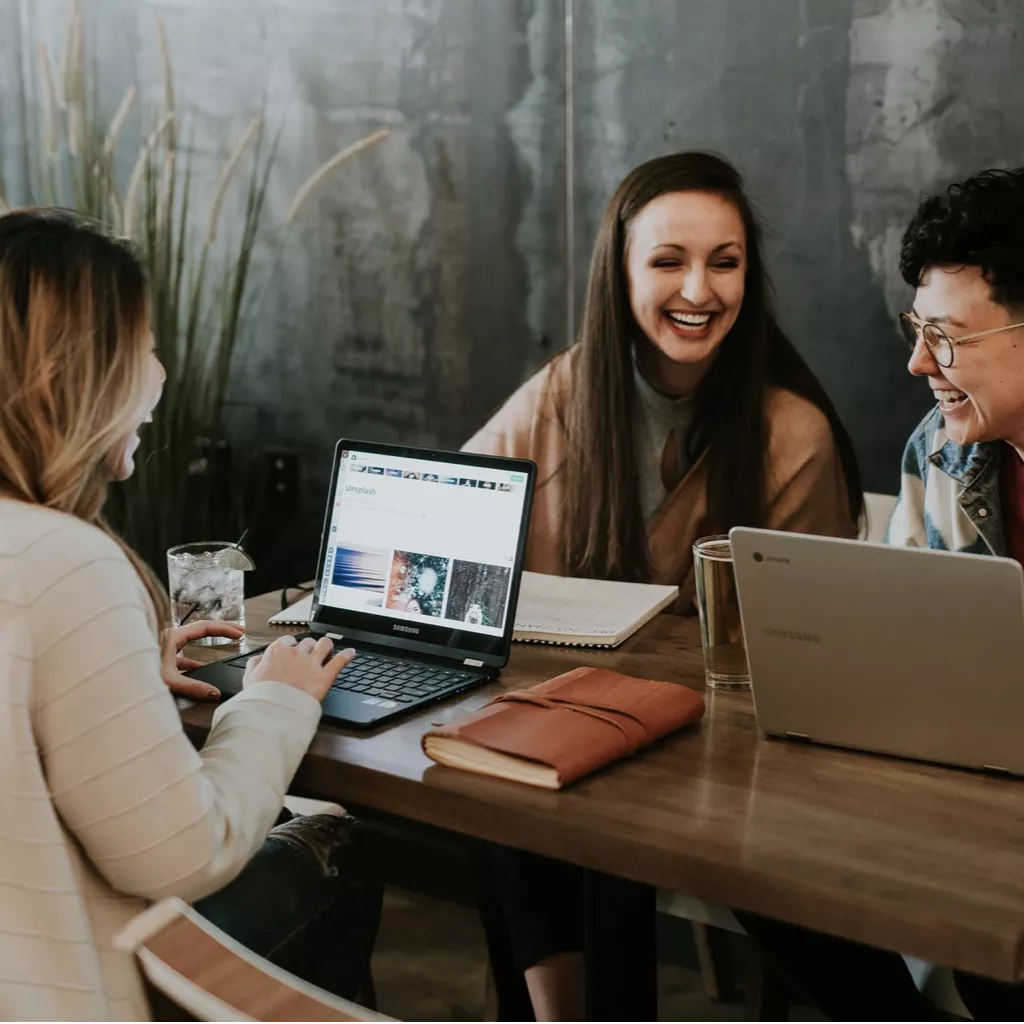 Three workers share a joke at work.