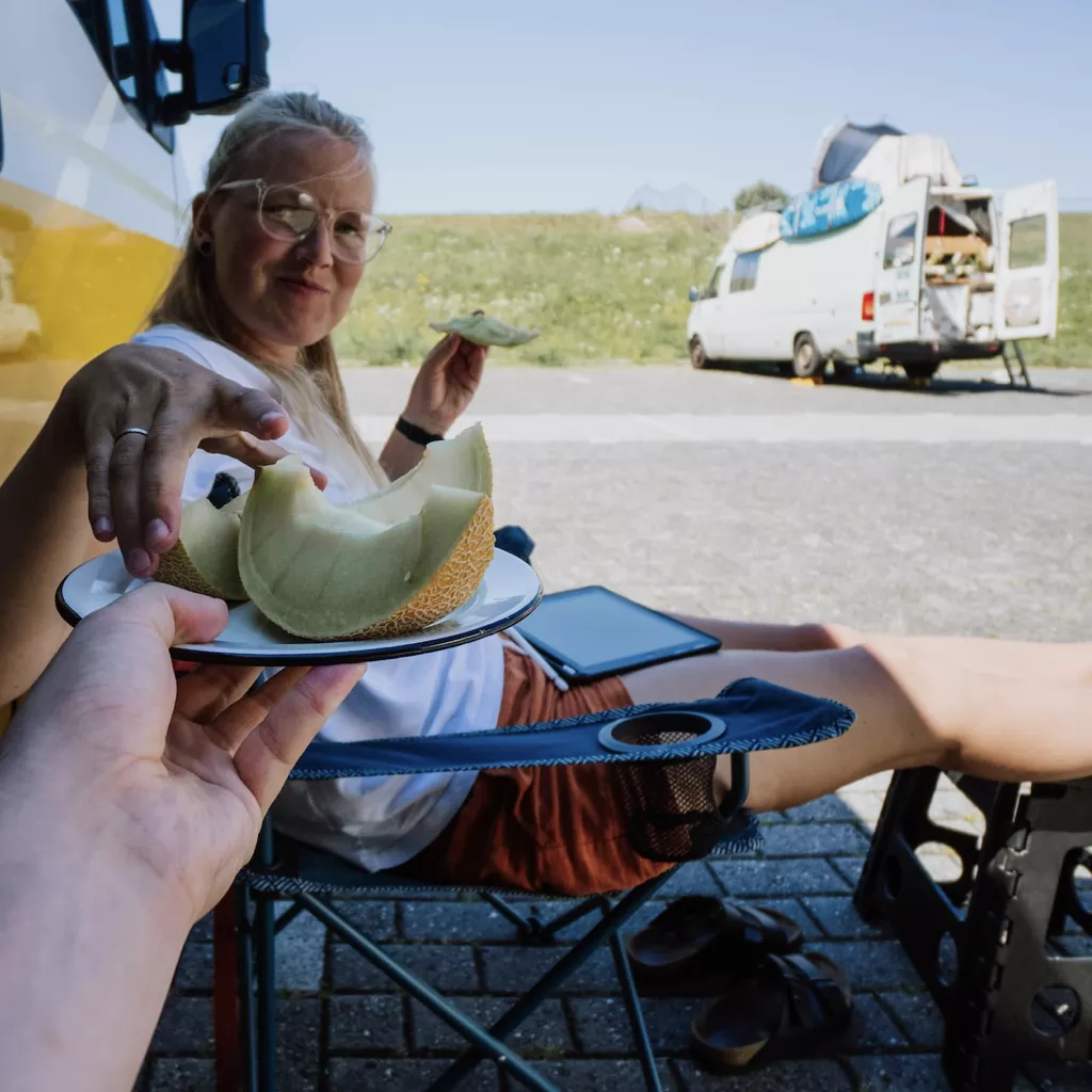 A couple having lunch outside their motorhome.