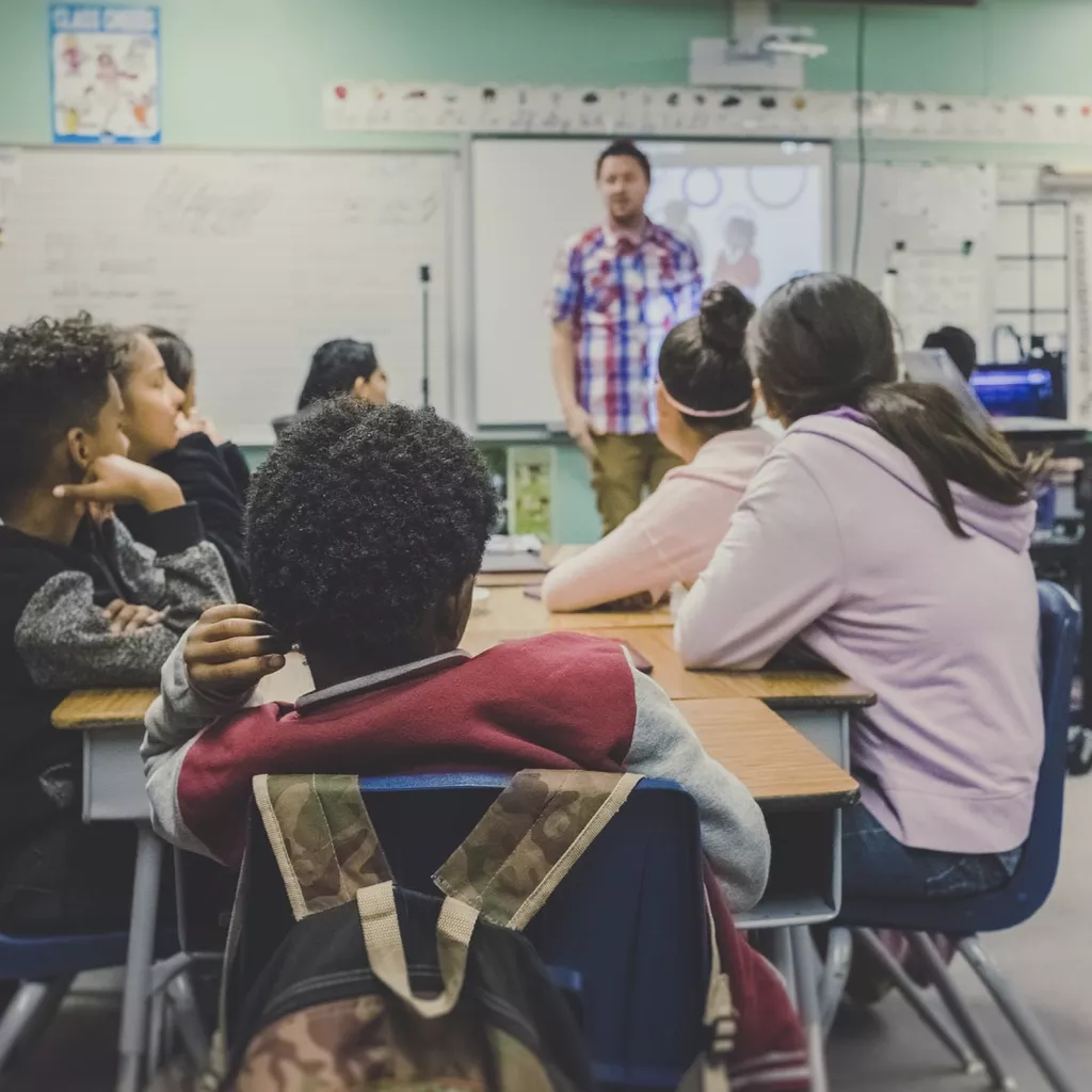 A modern school classwork, with the teacher standing at the front.