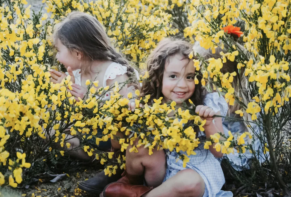 Authentic moments, like these girls playing in nature, create long-lasting childhood memories.