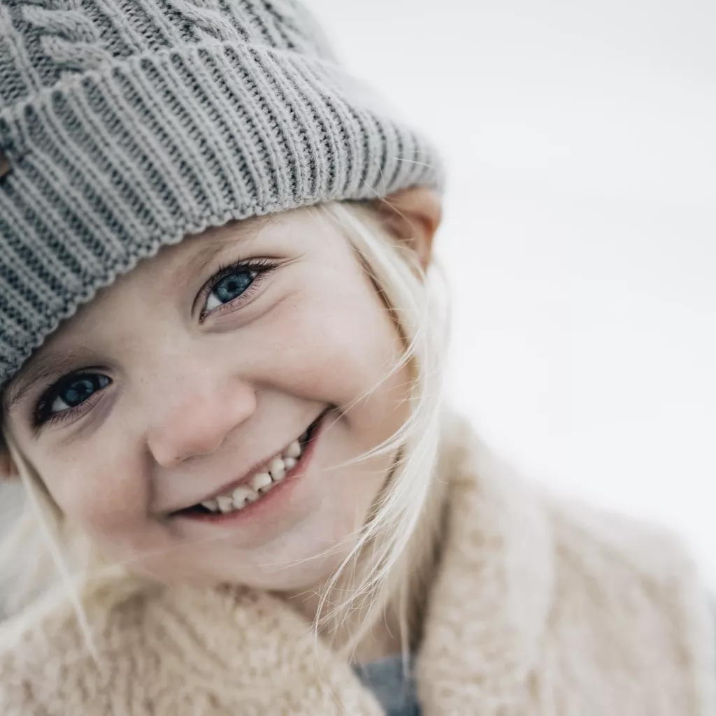 A young girl smiling into the camera.