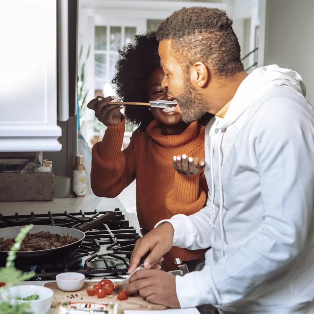 A couple cooking in the kitchen.