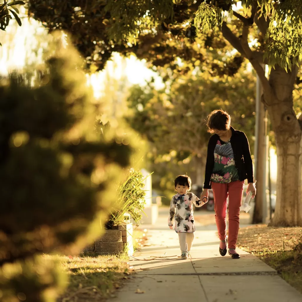 A mother with her child on their daily walk to school.