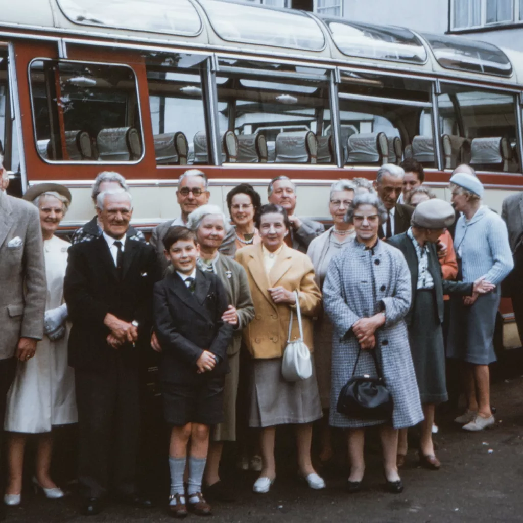 An old photo of people about to set off on a coach trip.