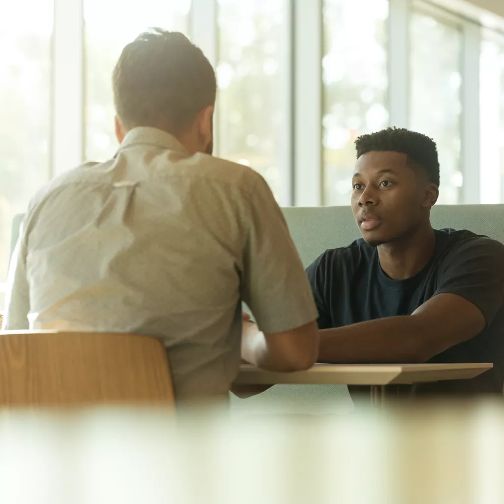 Two men in a serious conversation.