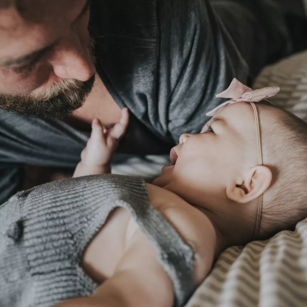 A father looking at his baby.