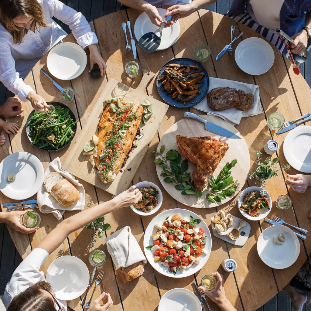 A garden table covered with delicious-looking food.