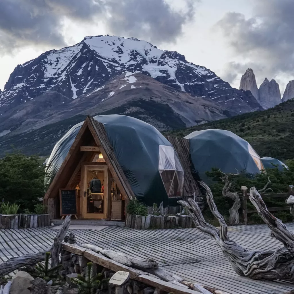 An exotic-looking building in front of a mountain.