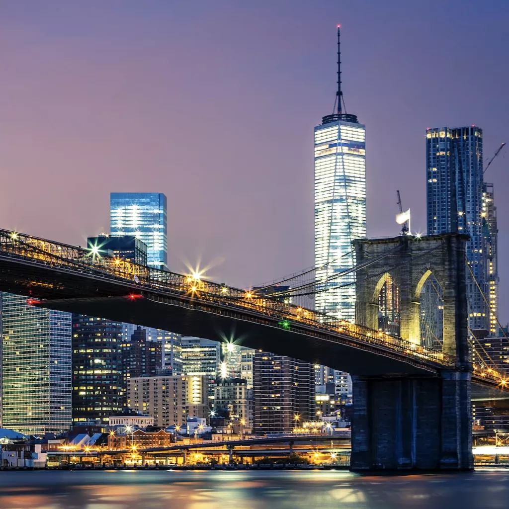 An impressive city skyline at night.