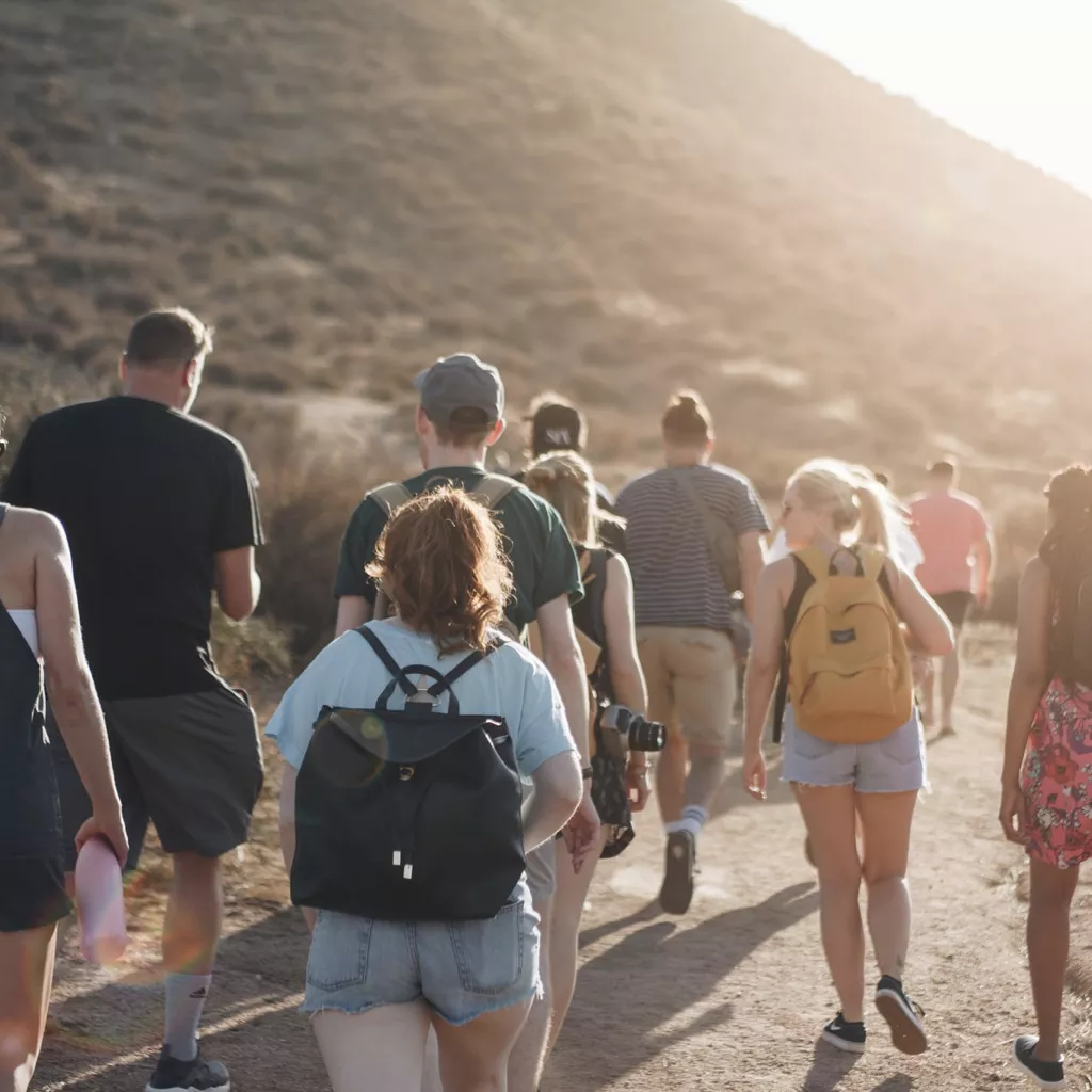 A big group of people going on a walk.