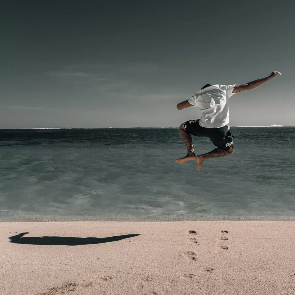 A happy man jumping for joy.